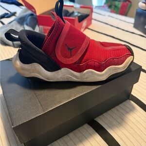 Kids 1Y Jordans. Red, black and white with Velcro strap.